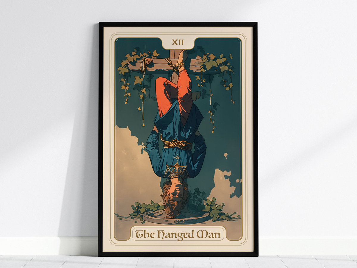 A framed artwork titled The Hanged Man, featuring a figure hanging upside down with a serene expression. The character is dressed in a blue top and red pants, surrounded by green vines against a muted background.