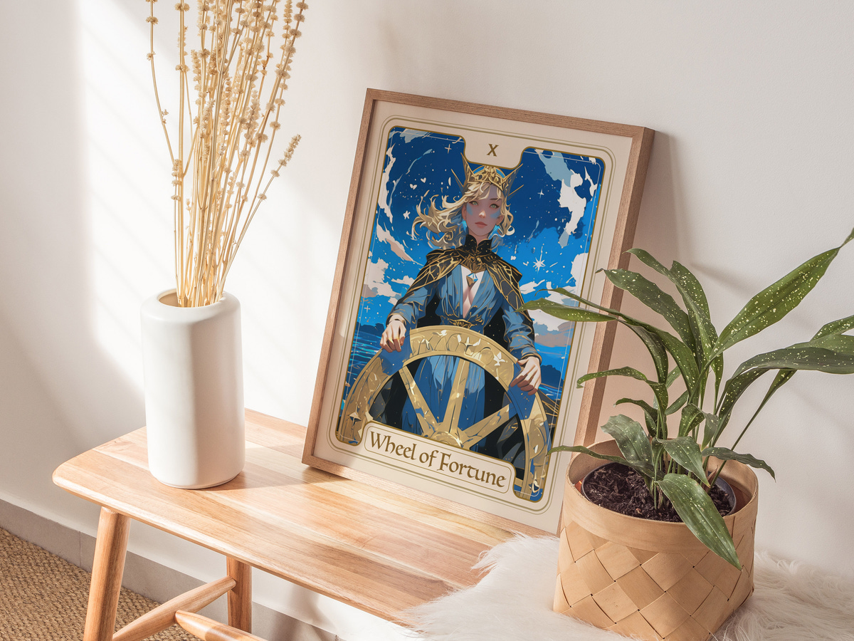 A framed illustration of a figure representing the Wheel of Fortune stands on a wooden table, surrounded by a potted plant and a vase with dried flowers.