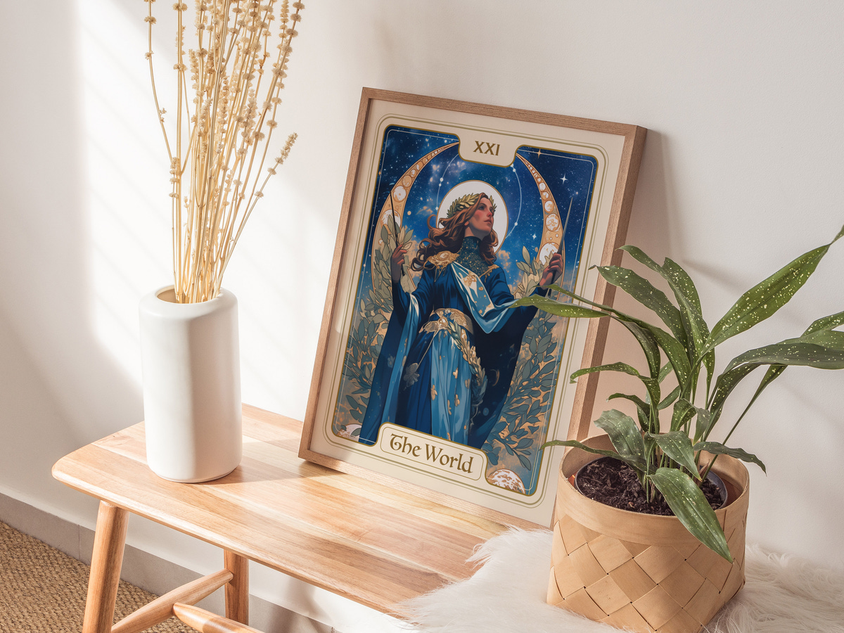 A beautifully framed artwork titled The World features a female figure adorned in blue and gold, surrounded by celestial elements and greenery.
