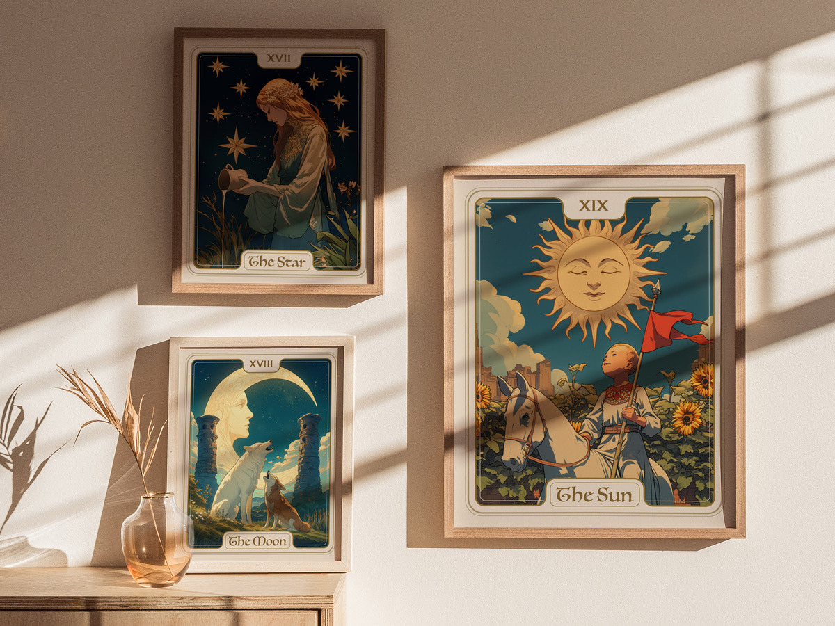 A bright, sunlit room features three framed art prints on the wall, showcasing whimsical tarot card designs. The central piece, titled The Sun, depicts a smiling sun character against a vibrant blue background, surrounded by sunflowers.