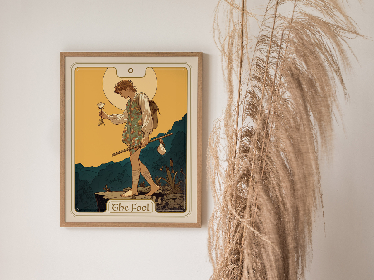 A framed art print titled The Fool features a young figure holding a flower, dressed in a colorful outfit, standing on a grassy hill with a bright yellow background.