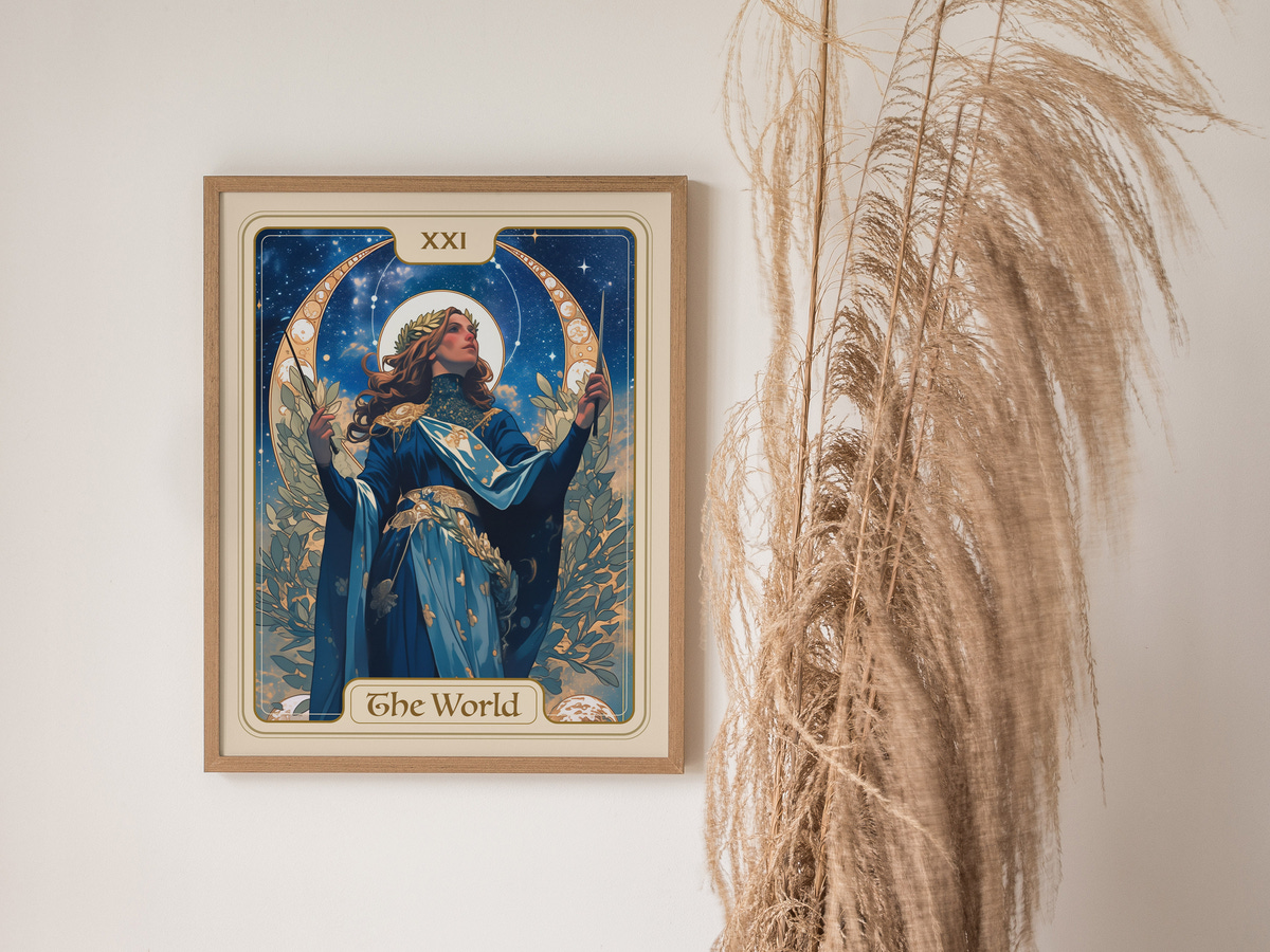 A framed art print titled The World, featuring a woman in a flowing blue dress adorned with gold accents, holding a wand and surrounded by celestial motifs.