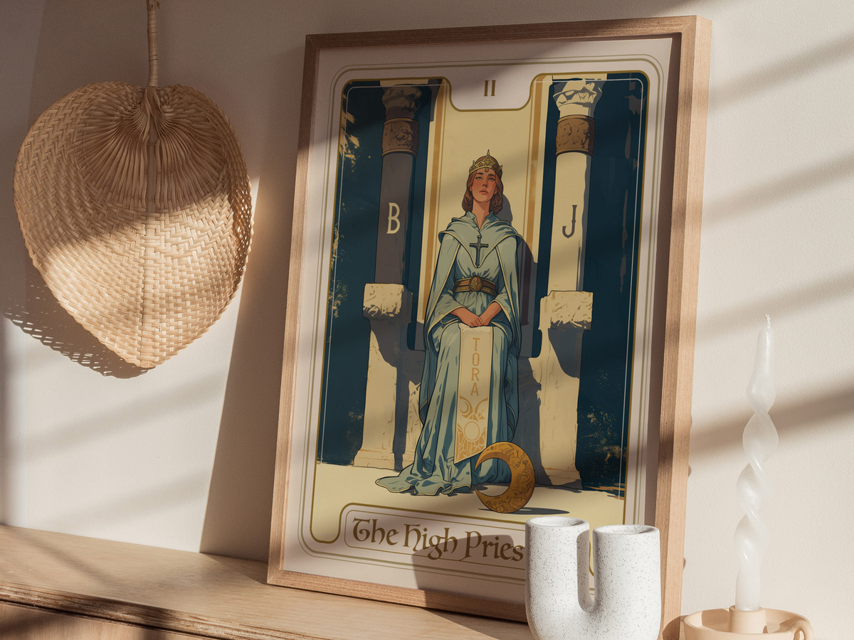 A framed illustration of The High Priestess tarot card, featuring a woman in a blue robe and crown, standing between two pillars labeled B and J. The background showcases a serene setting with soft sunlight casting shadows.