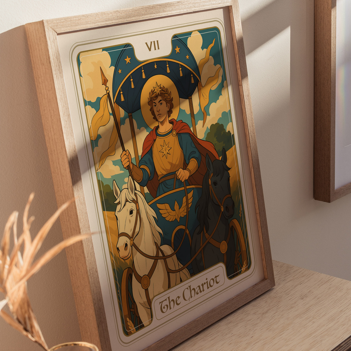 A framed illustration of The Chariot tarot card, featuring a young man in a blue and red outfit, holding a spear and standing between two horses—one white and one black—against a backdrop of clouds and stars.