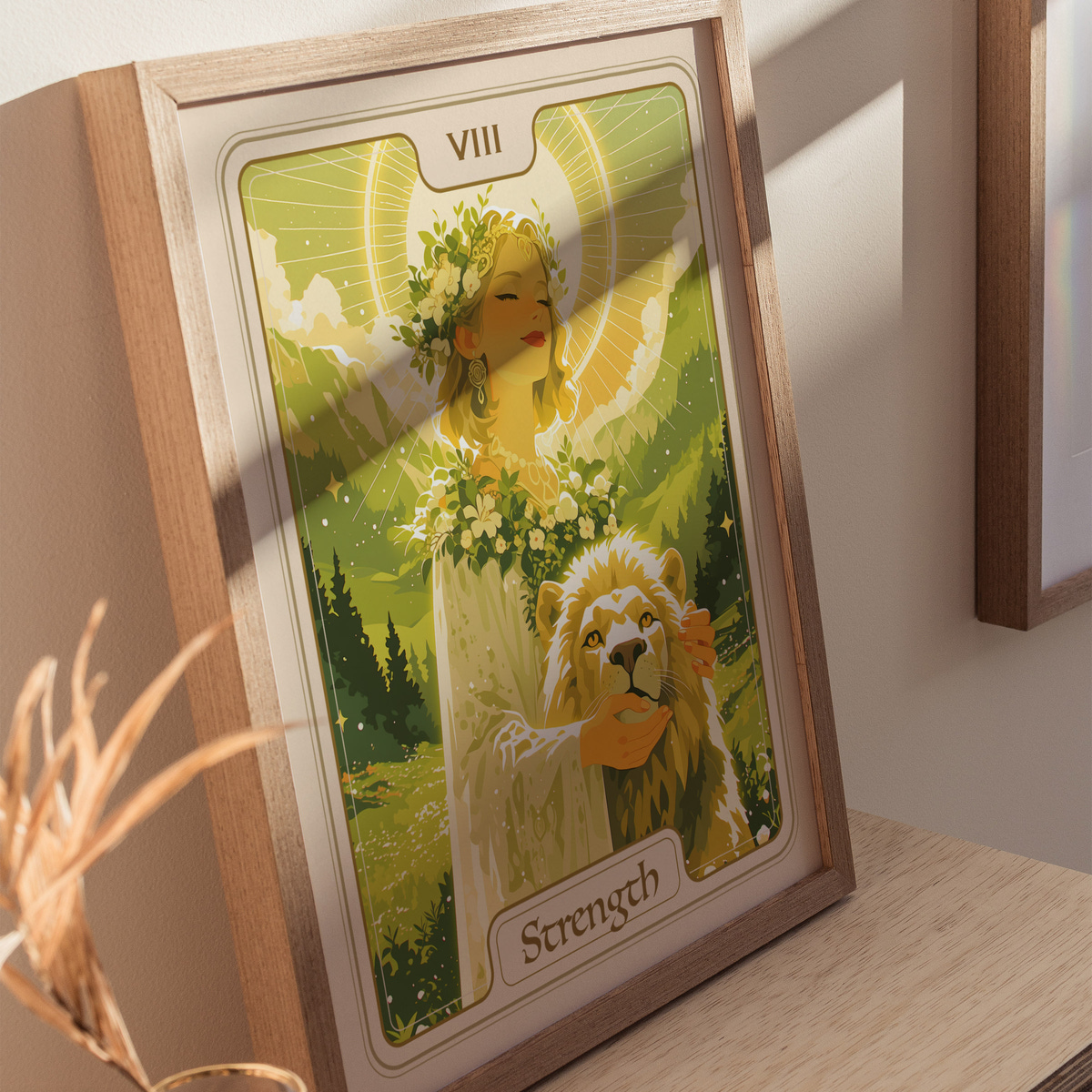 A beautifully illustrated art print titled Strength featuring a serene woman adorned with flowers, standing beside a lion in a lush green landscape. The image is framed in wood and illuminated by soft light, creating a calming atmosphere.