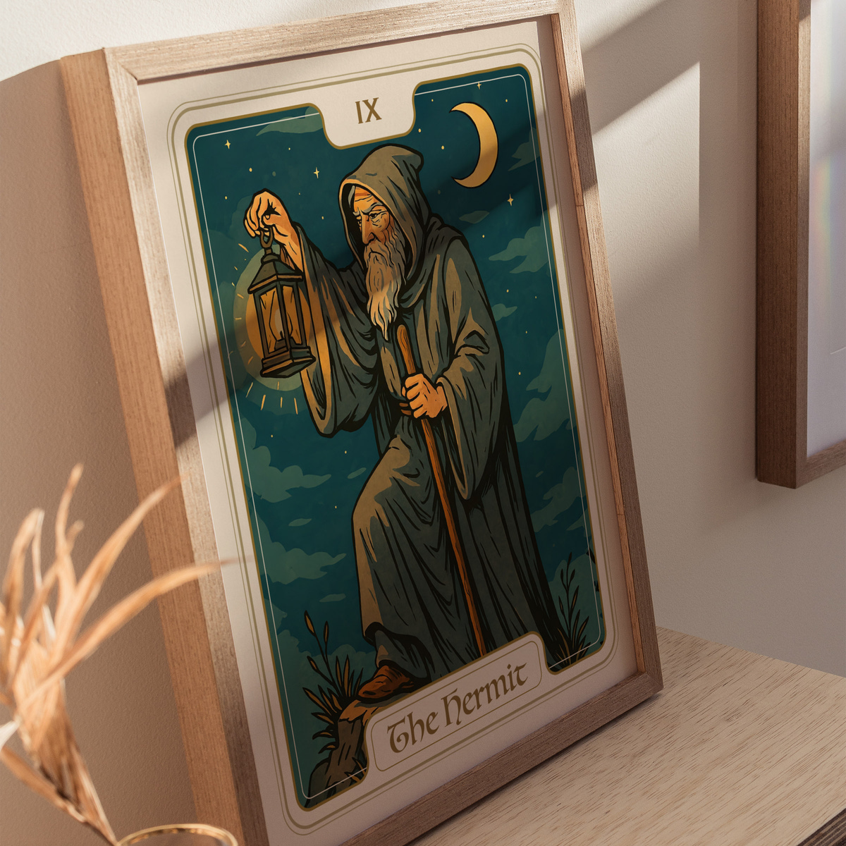 A framed tarot card titled The Hermit features an elderly figure in a hooded cloak holding a lantern, standing on a rocky terrain under a crescent moon. The background is filled with dark blue clouds, creating a mystical atmosphere.