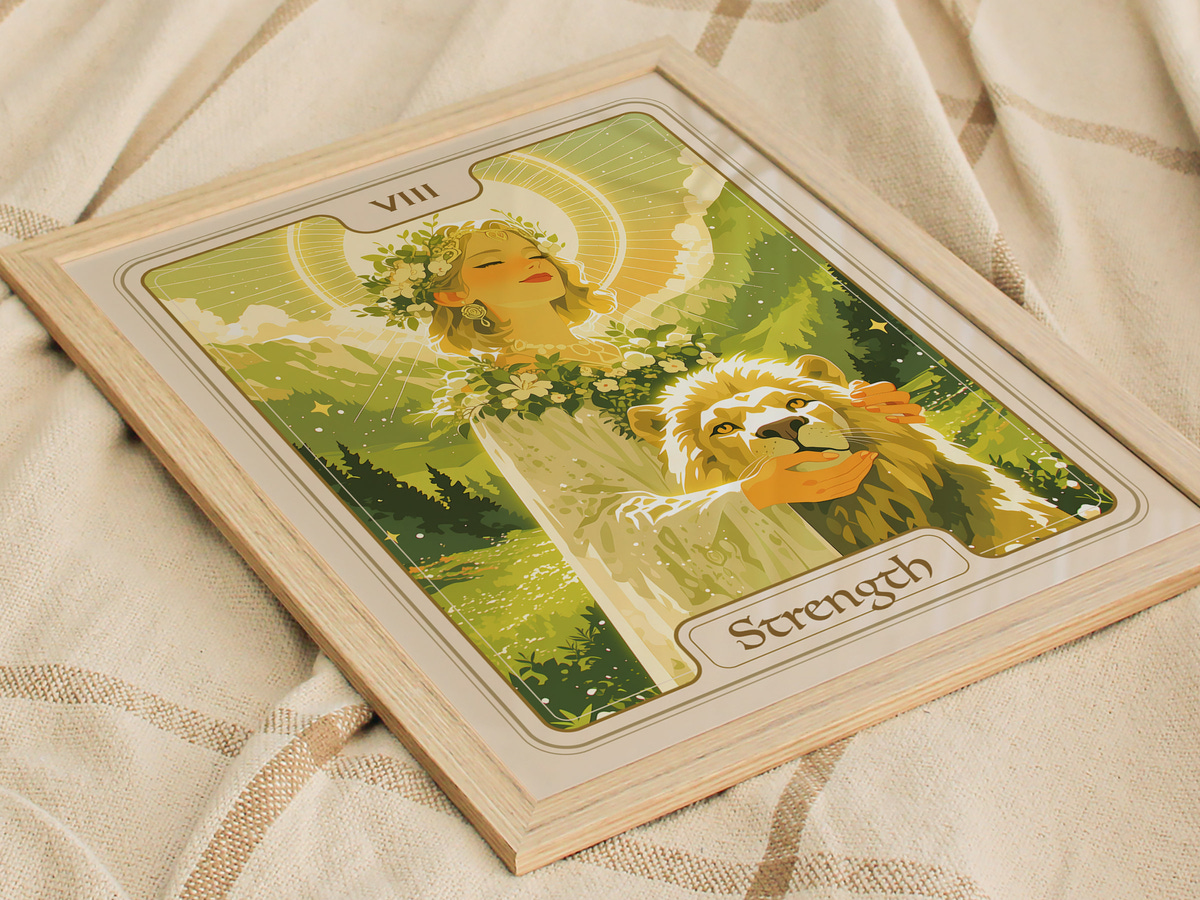 A beautifully illustrated art print featuring a serene figure adorned with a floral crown, holding a lions head and surrounded by a lush landscape. The design is framed in light wood and labeled Strength at the bottom.