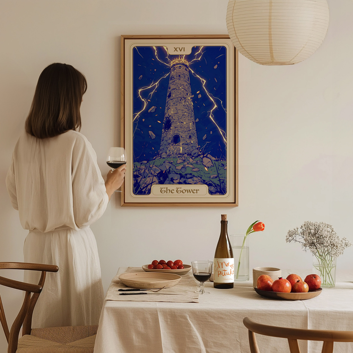 A woman in a white dress stands in a well-lit dining area, holding a glass of wine and gazing at a colorful poster of a tower surrounded by lightning.